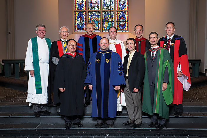 Seminary President Dr. Dale A. Meyer, top left, and Provost Jeffrey Kloha, bottom right, stand with the five new endowed chairs, two faculty and one new staff member after the Opening Service. They include, bottom row from left: Rev. Laokouxang (Kou) Seying, the Lutheran Foundation Professor of Urban and Cross-Cultural Ministry; Dr. David R. Maxwell, Louis A. Fincke and Anna B. Shine Professor of Systematic Theology; and James F. Marriott, director of musical arts. Top row from left: Dr. James W. Voelz, the Dr. Jack Dean Kingsbury Professor of New Testament Theology; Dr. Mark Seifrid, professor of exegetical theology; Dr. Kent J. Burreson, the Louis A. Fincke and Anna B. Shine Professor of Systematic Theology;  Dr. Charles P. Arand, the Eugene E. and Nell S. Fincke Graduate Professor of Theology; and Dr. Robert Rosin, the Eugene E. and Nell S. Fincke Graduate Professor of Theology.