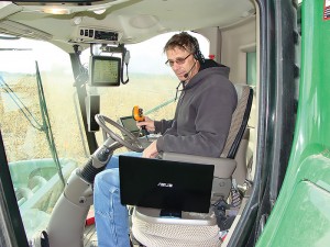 Thanks to modern technology, Vicar Steve Struecker is able to participate in online courses and discussions while out in the field in his combine, Nov. 2, 2013. Photo: Kathleen Struecker.
