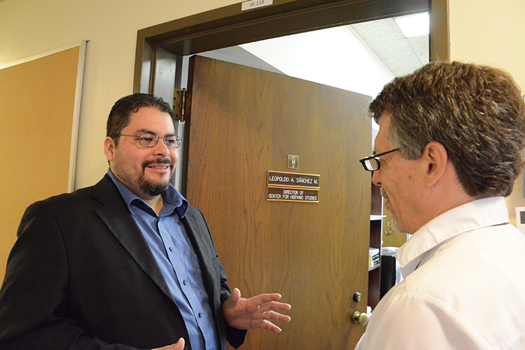 Professor Leopoldo A. Sánchez M., left, chats with Mark Kempff, assistant to the director of the Center for Hispanic Studies.