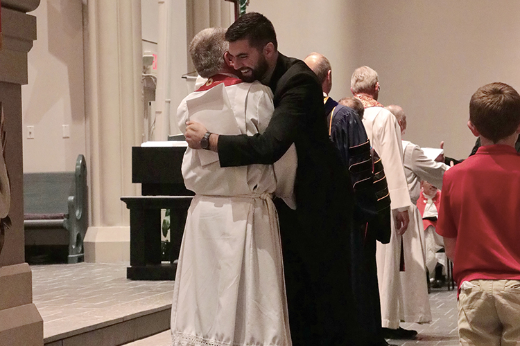Seminary President Dr. Dale A. Meyer, left, gives Dustin Atkinson a hug on Call Day 2017.